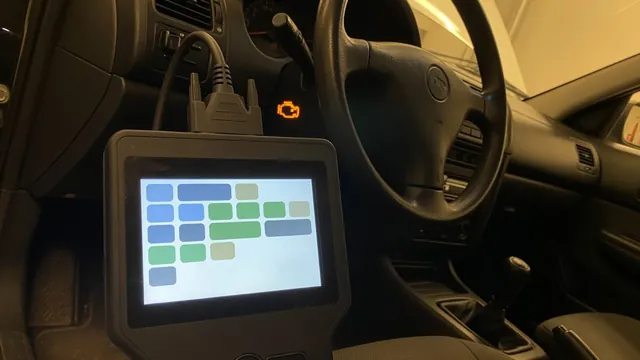 OBD-II scan tool connected under a car dashboard with the check engine light on