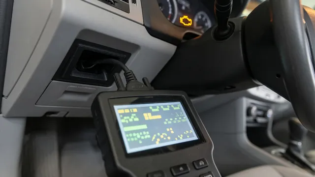 OBD-II scan tool connected under a car dashboard showing a trouble code with the check engine light on