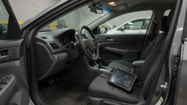 Diagnostic scanner connected inside a parked vehicle during a trouble code assessment