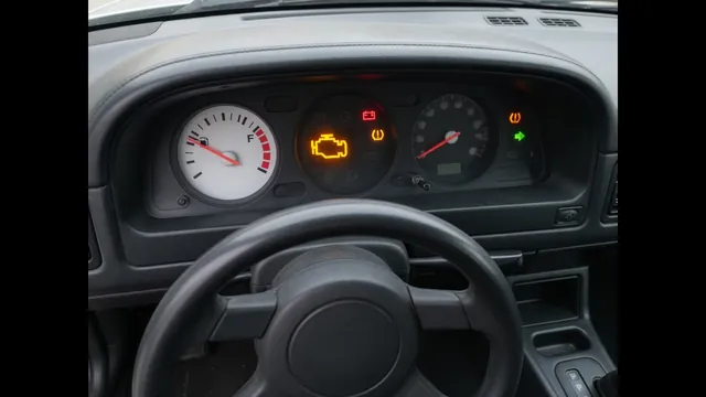 Vehicle instrument cluster with a fuel gauge and an illuminated check engine light