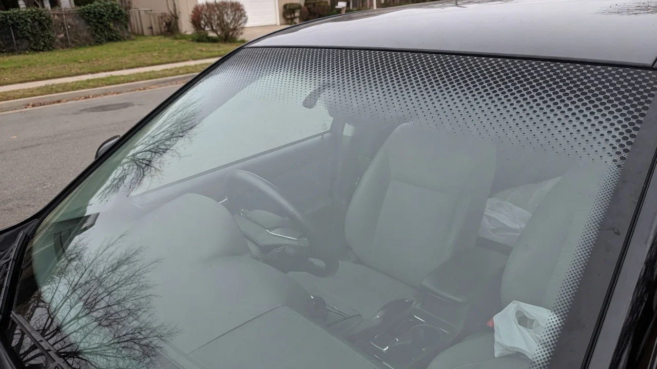 Automotive scene illustrating Why Does a Windshield Have a Black Dotted Border