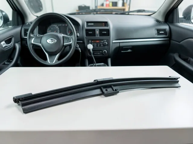 Wiper blade frame with a separate rubber refill and retaining rails on a clean workbench