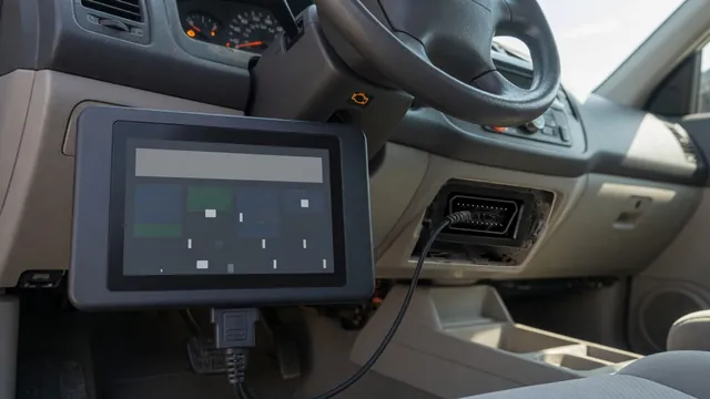 OBD-II scan tool connected under a car dashboard reading a trouble code, with the engine warning light lit