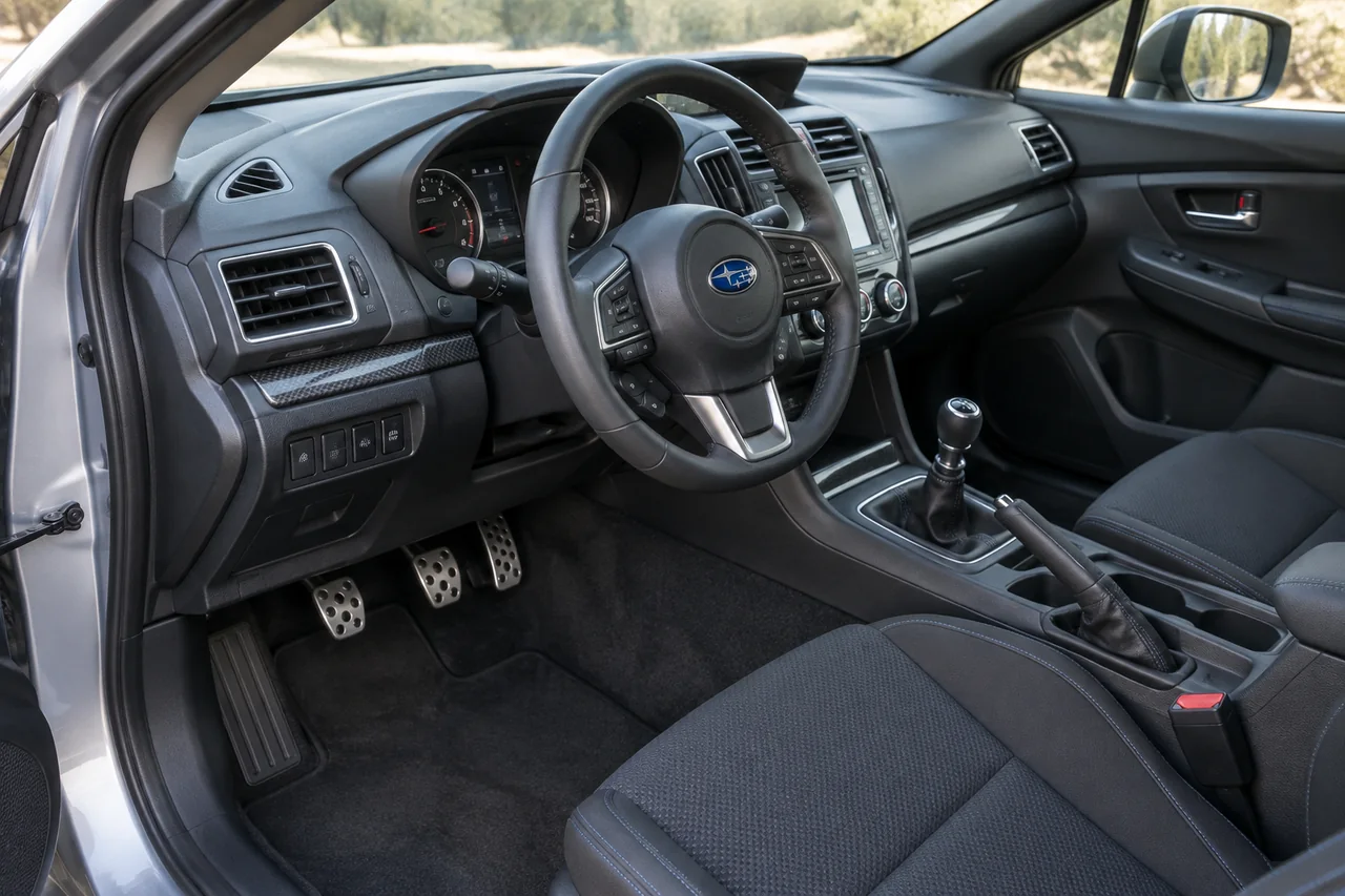 Manual gearshift and clutch pedal in a Subaru cabin with no visible model-year identifiers