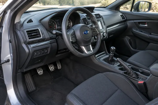 Manual gearshift and clutch pedal in a Subaru cabin with no visible model-year identifiers