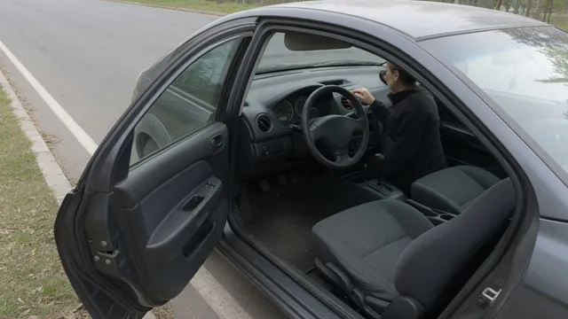 Driver observing the dashboard while seated in a parked car with the engine idling