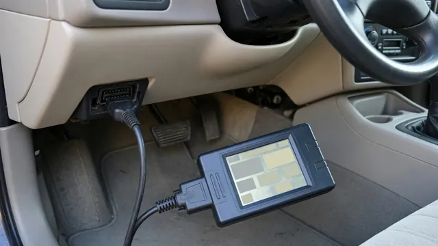 OBD-II scan tool connected under a car dashboard to read a P1646 trouble code