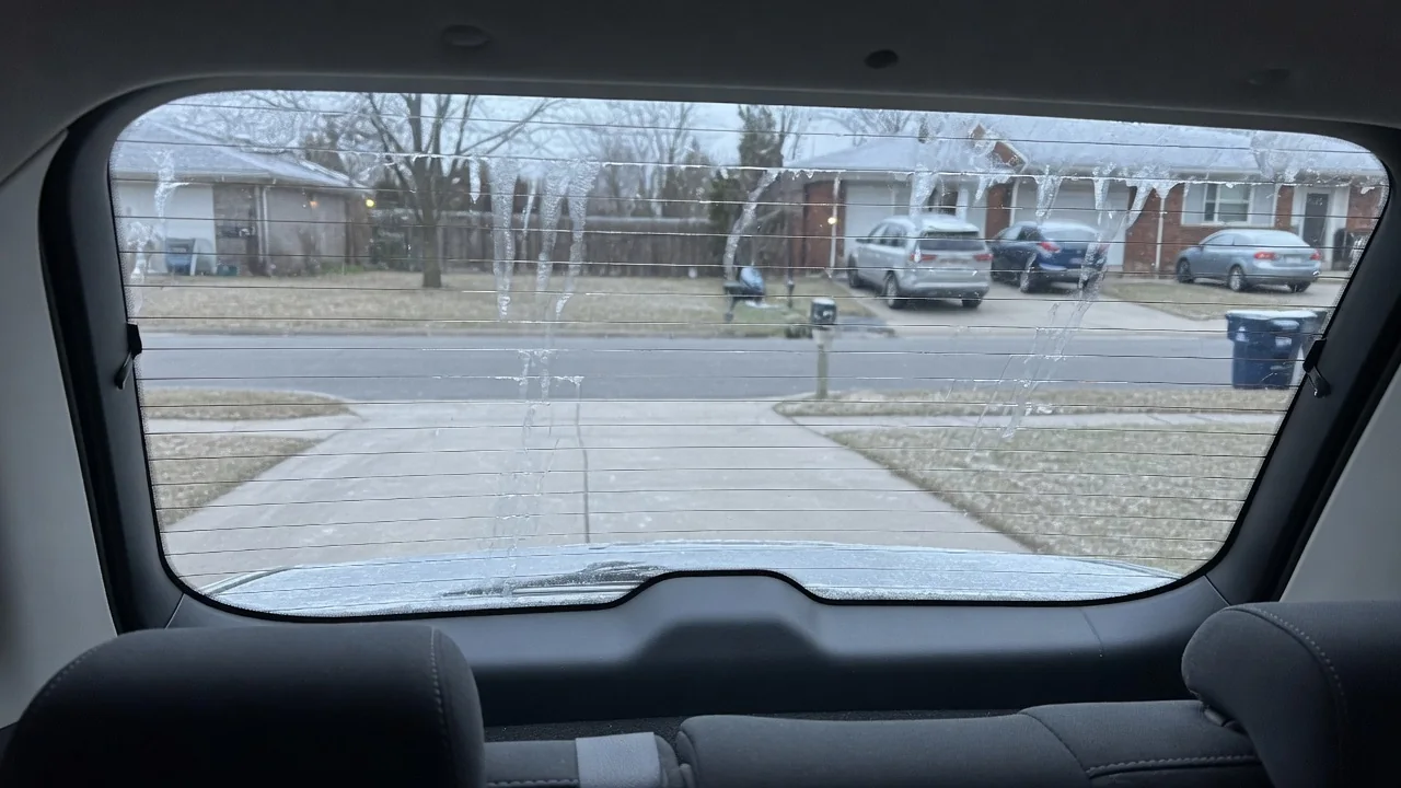 Automotive scene illustrating Why Does the Rear Window Defroster Use Thin Lines
