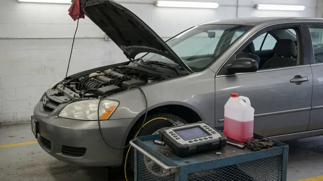 Transmission diagnostic scanner beside a parked vehicle with its hood open
