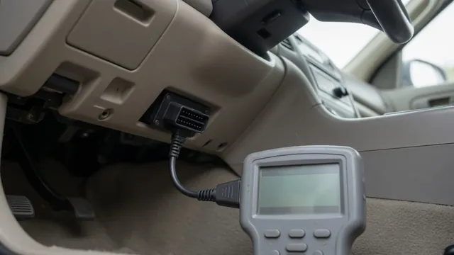 Handheld scan tool plugged into a car's diagnostic port, showing stored body system trouble codes