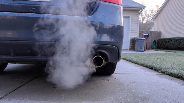White smoke coming from a car's exhaust pipe while the engine idles on a cool morning