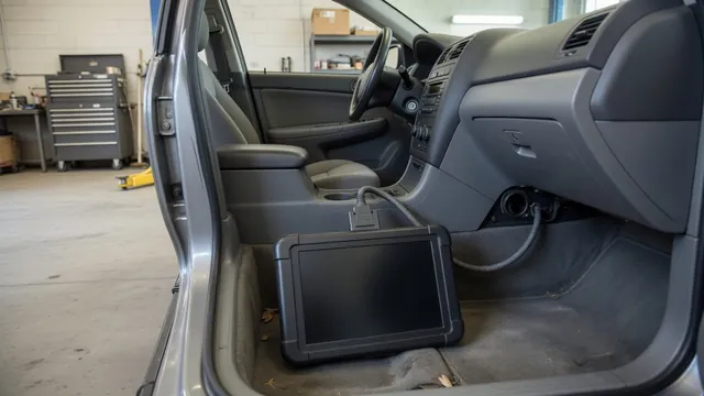 Diagnostic scanner connected inside a parked vehicle during a trouble code check