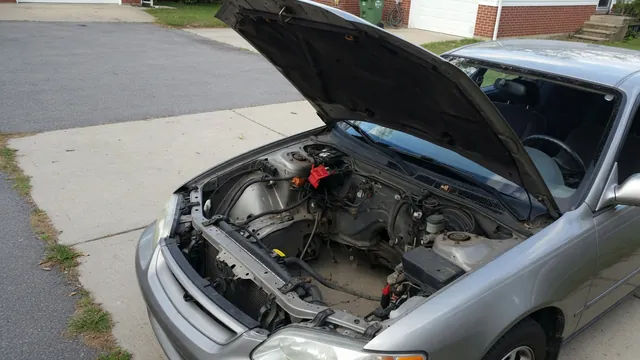 Parked car with its hood open for a visual inspection of an engine bay hissing noise