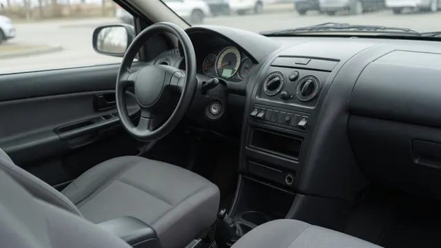 Car dashboard showing climate controls and a tachometer while the engine idles