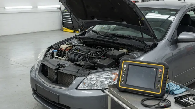 Scan tool displaying P0112 beside an intake air temperature sensor connector in an engine bay