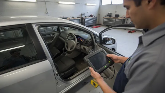 Technician using a diagnostic scan tool to investigate an ABS warning light on a parked vehicle