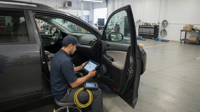 Diagnostic scanner beside a vehicle dashboard with a technician reviewing service information