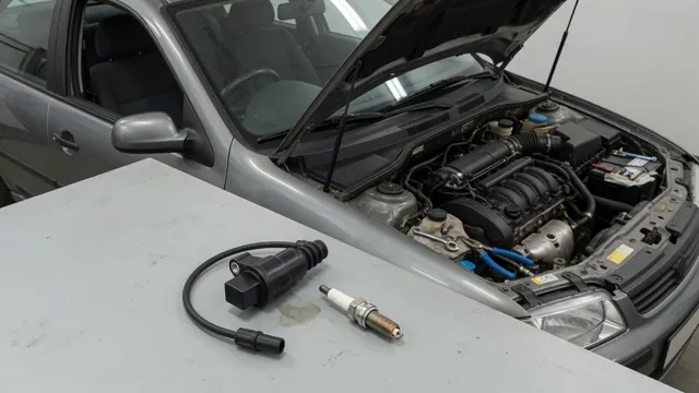 Ignition coil and spark plug on a workbench beside a Nissan engine bay