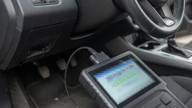 OBD-II scan tool plugged in under a car dashboard to read manufacturer-specific trouble codes