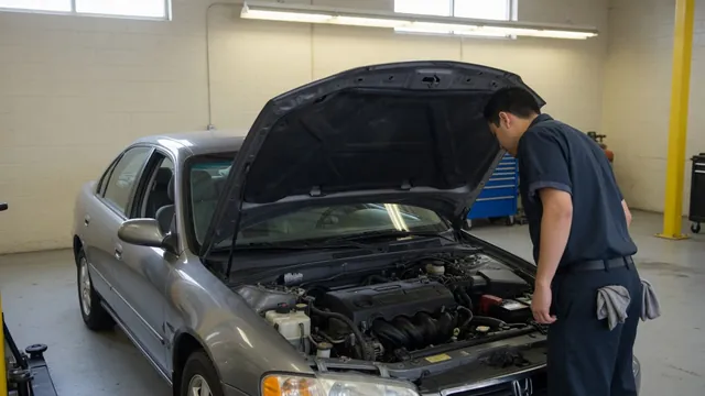 Honda S2000 in a service bay with its hood open for timing chain tensioner inspection