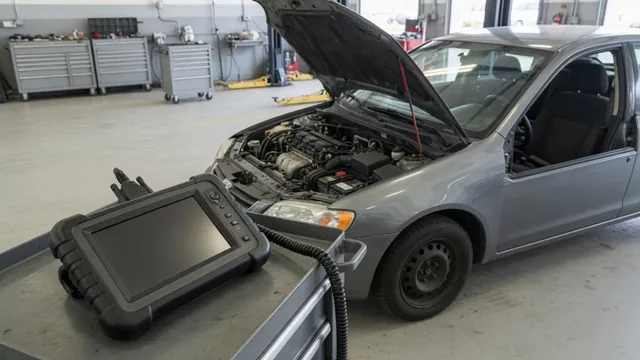 Diagnostic scanner beside a parked vehicle with its hood open
