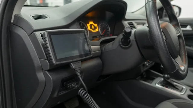 OBD-II scan tool plugged into a car's diagnostic port, with the check engine light on in the background