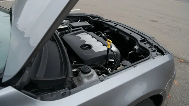 Oil dipstick and oil filler cap in an engine bay with the engine off