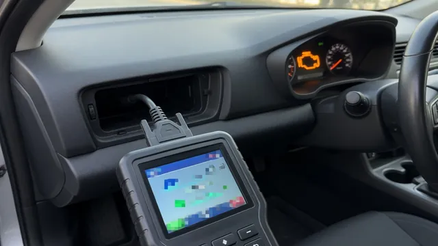 OBD-II scan tool plugged into a car's diagnostic port, reading a trouble code while the check engine light is on