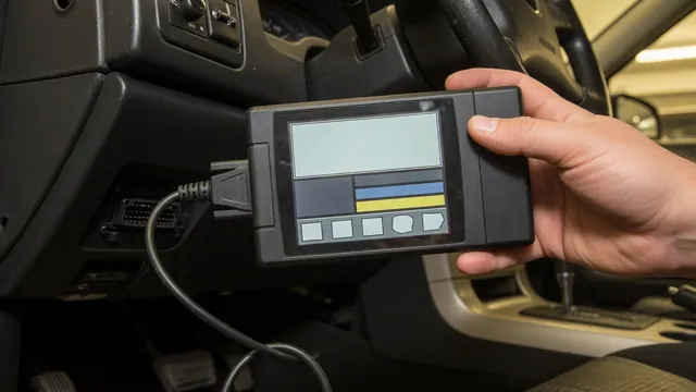 OBD-II scan tool plugged in under a car dashboard to read a stored trouble code