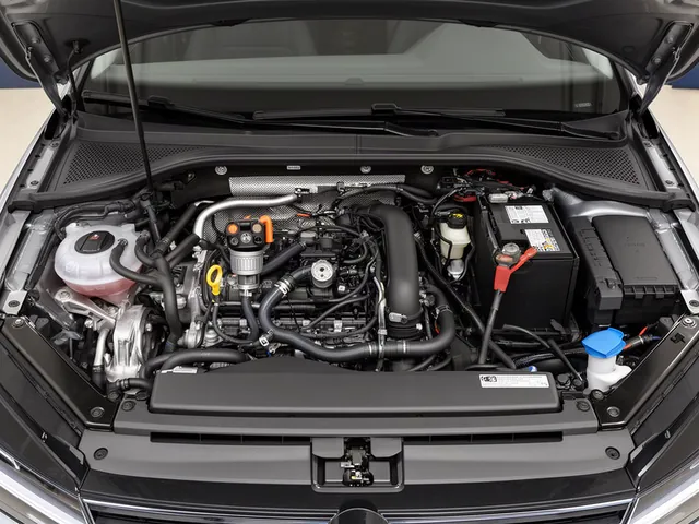 Illustration of a crankcase ventilation regulator and hoses within a Volkswagen engine bay