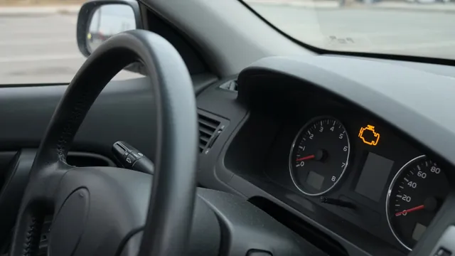 Dashboard check engine light and tachometer in a parked gasoline vehicle