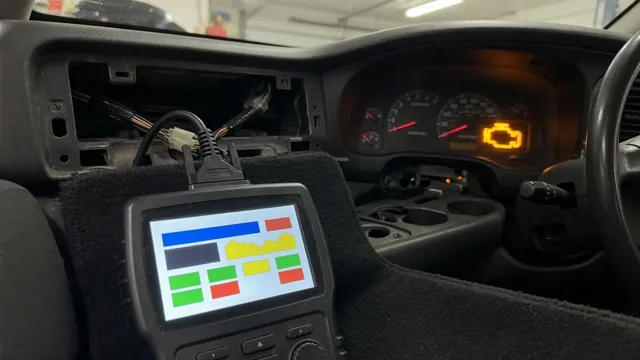 OBD-II scan tool plugged in under a car dashboard, reading a trouble code while the check engine light is on