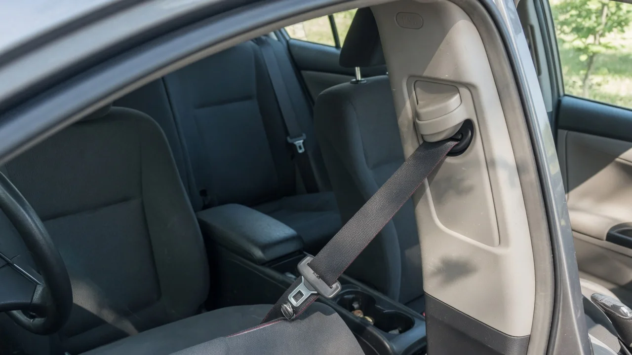 Automotive scene illustrating Why Does a Seat Belt Tap Against Interior Trim
