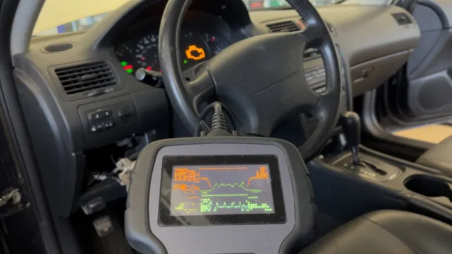 OBD-II scan tool plugged in under a car dashboard to read a trouble code, with the check engine light on