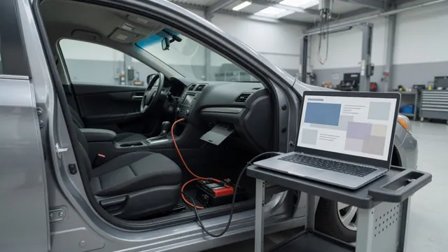 Laptop running a control module programming session through a car's OBD-II port with a battery maintainer attached