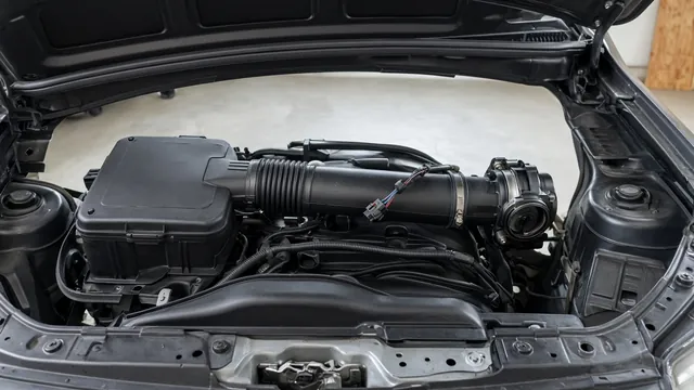 Engine bay of a compact SUV showing the air filter box, intake duct, and a sensor connector