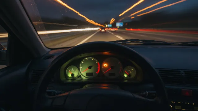 Dashboard tachometer at high rpm with a check engine light on during highway driving