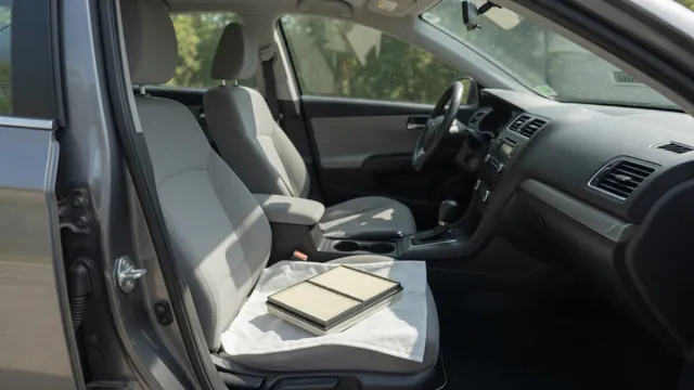 Car dashboard vents and an accessible cabin air filter during an AC odor inspection