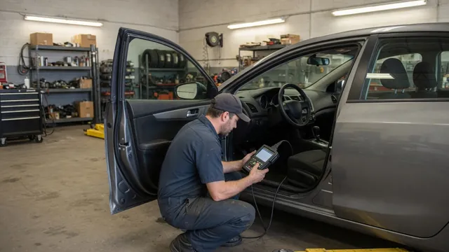 Diagnostic scanner connected beneath a vehicle dashboard while a technician reviews vehicle information
