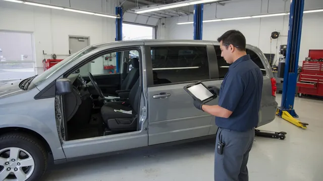 Honda minivan parked in a service bay while a technician reviews diagnostic information