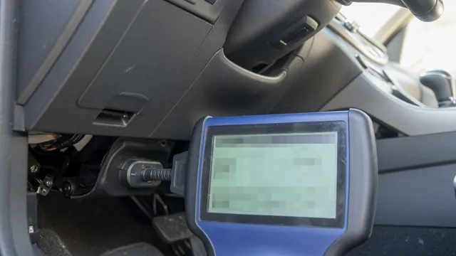 Handheld OBD-II scan tool connected under a car dashboard showing a P1188 trouble code