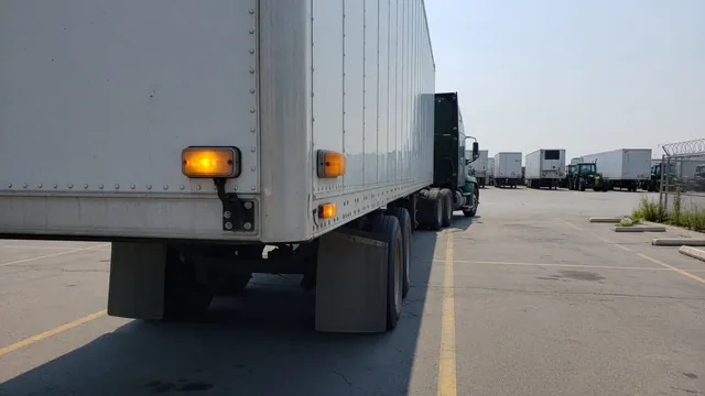 Amber ABS indicator on the left rear side of a parked semi trailer