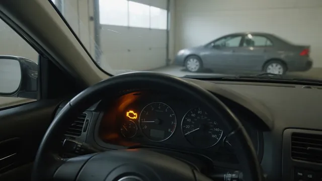 Illuminated check engine symbol on a dashboard with a Mazda parked in the background
