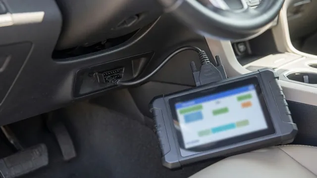 Handheld OBD-II scanner plugged into a car's diagnostic port under the dashboard to read a trouble code