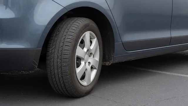 Car parked safely with a close view of its front wheel and surrounding pavement