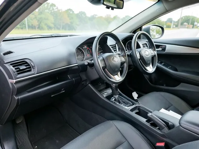 Toyota Corolla passenger glove box open beside a pleated cabin air filter ready for installation