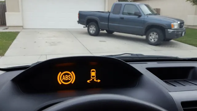 Illustration of illuminated ABS and VSC warning indicators beside a parked pickup