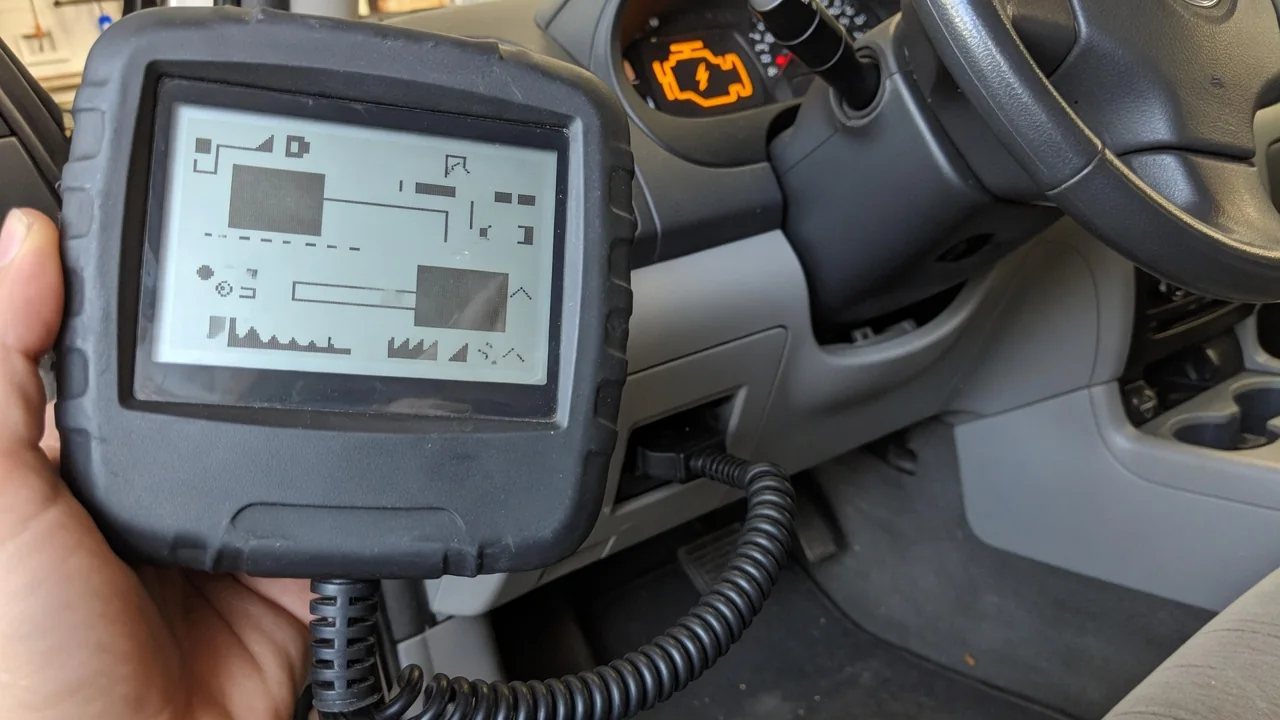 OBD-II scan tool plugged into a car's diagnostic port, reading a trouble code, with a check engine light in the background