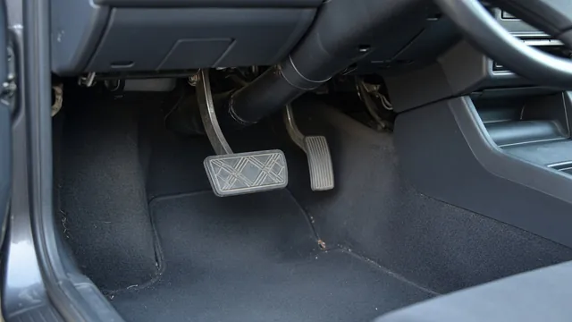 Driver footwell showing the brake pedal, pedal arm and return spring area