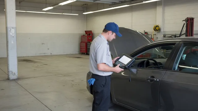 Diagnostic scan tool beside a parked vehicle with a technician reviewing fault information